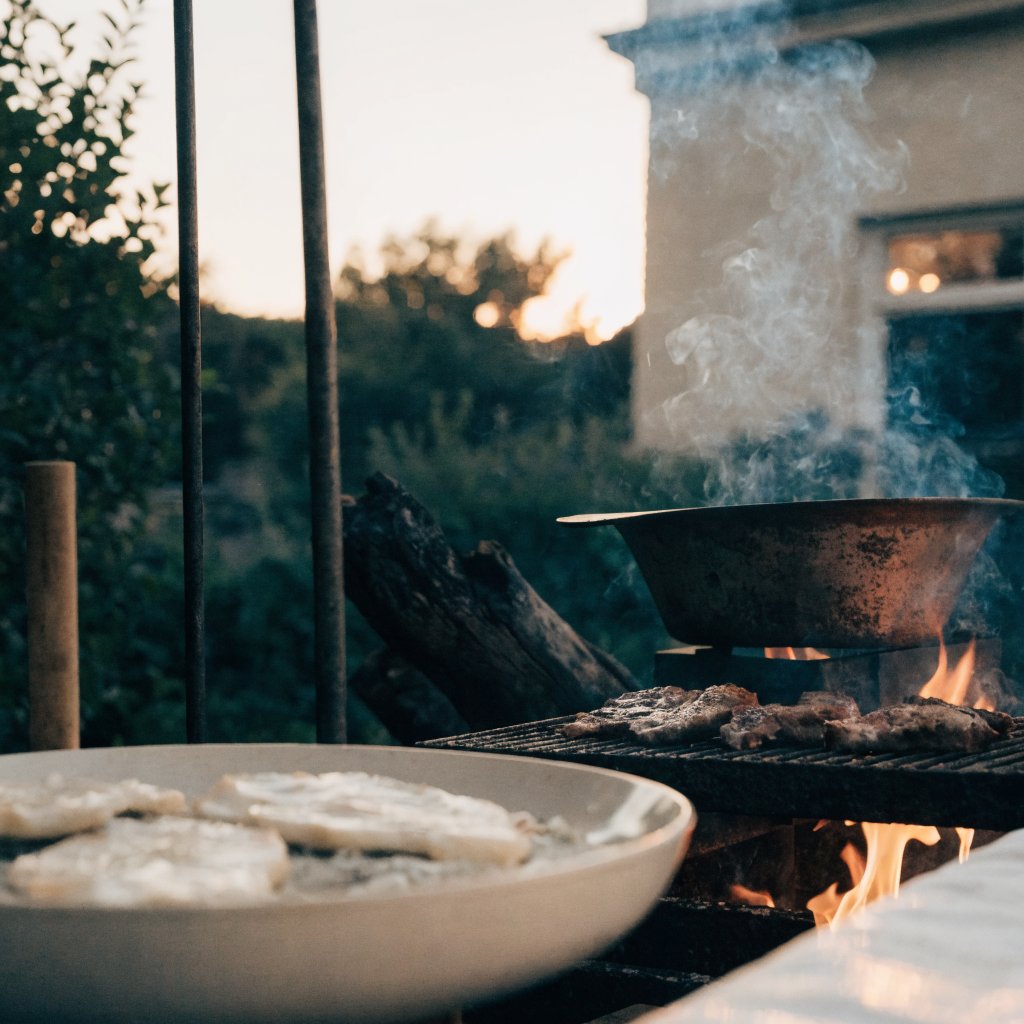 An outdoor dining table set for an intimate private dinner at dusk